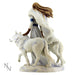 Back view of maiden with two white wolves. Showing her brown hair blowing and fur cloak