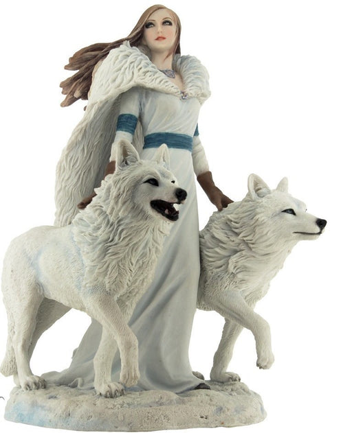 Figurine of a woman in white and a fur cloak, standing with two white wolves
