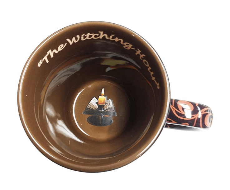 Inside of mug, brown background with "The Witching Hour" text and an image of a book and candle at the bottom of the cup