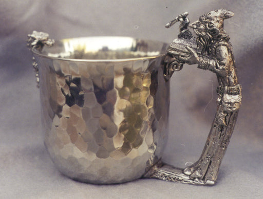 dragn looking inside pewter cup with wizard casting a spelling into the cup for a handle